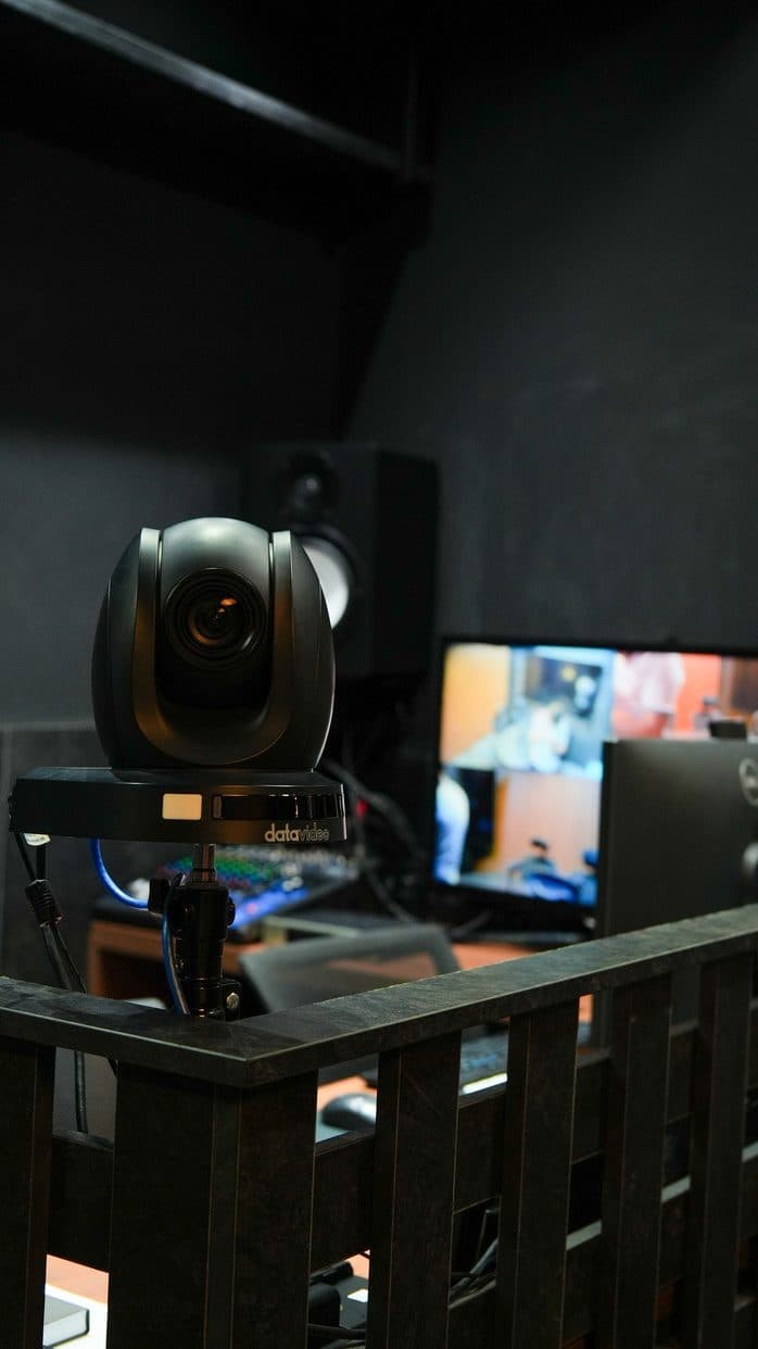 Câmera do estúdio ao lado de monitor de acompanhamento em tempo real